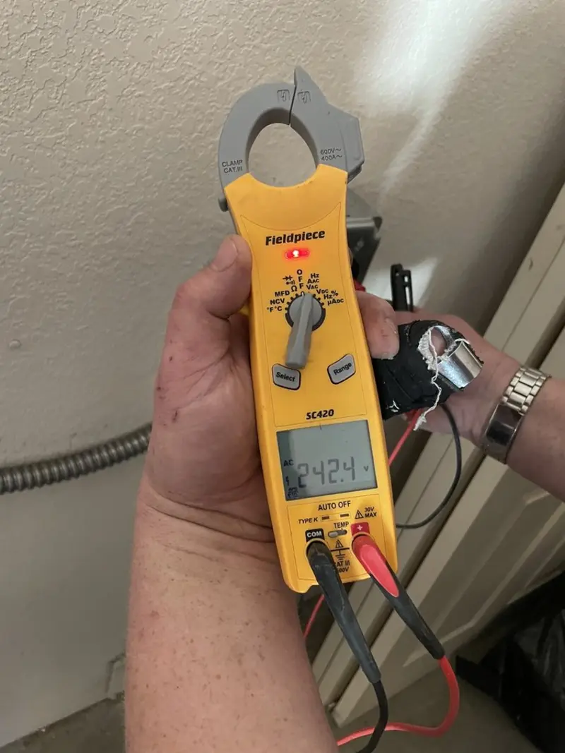 Voltage testing with clamp meter during Electrical Installation Services in Crystal City